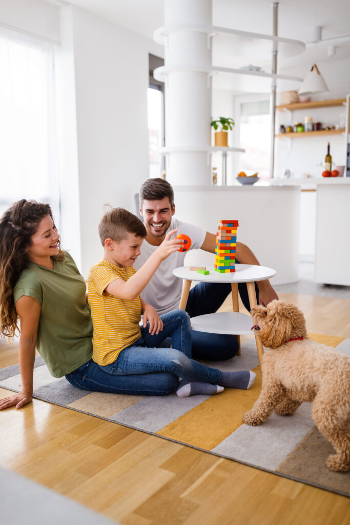 Happy family having fun, playing board game at home